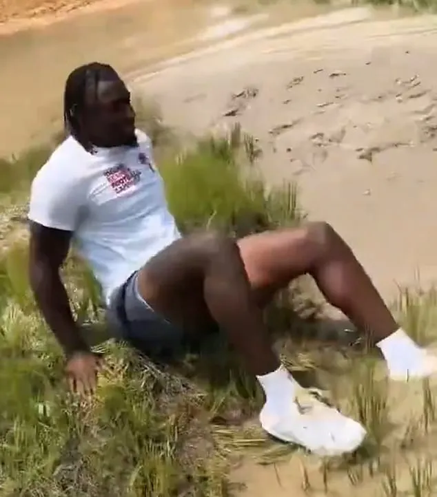 Incredible moment brave NFL star hops into thick mud to rescue stranded driver 99904525 14865733 Image A 49 1751394386149